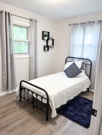 a bedroom with bed and window