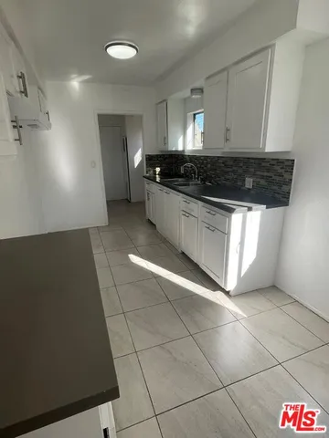 a kitchen with a cabinets and a stove top oven