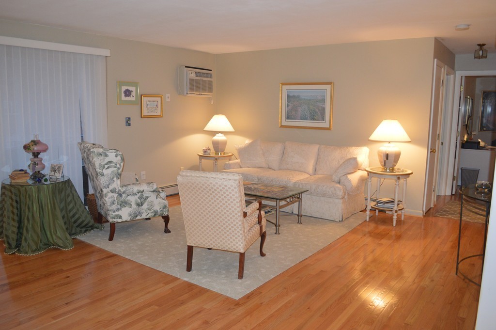 64 Jacqueline Road, Unit 5 Waltham, MA 02452 - Photo 5 of 10 a living room with furniture a lamp and a lamp