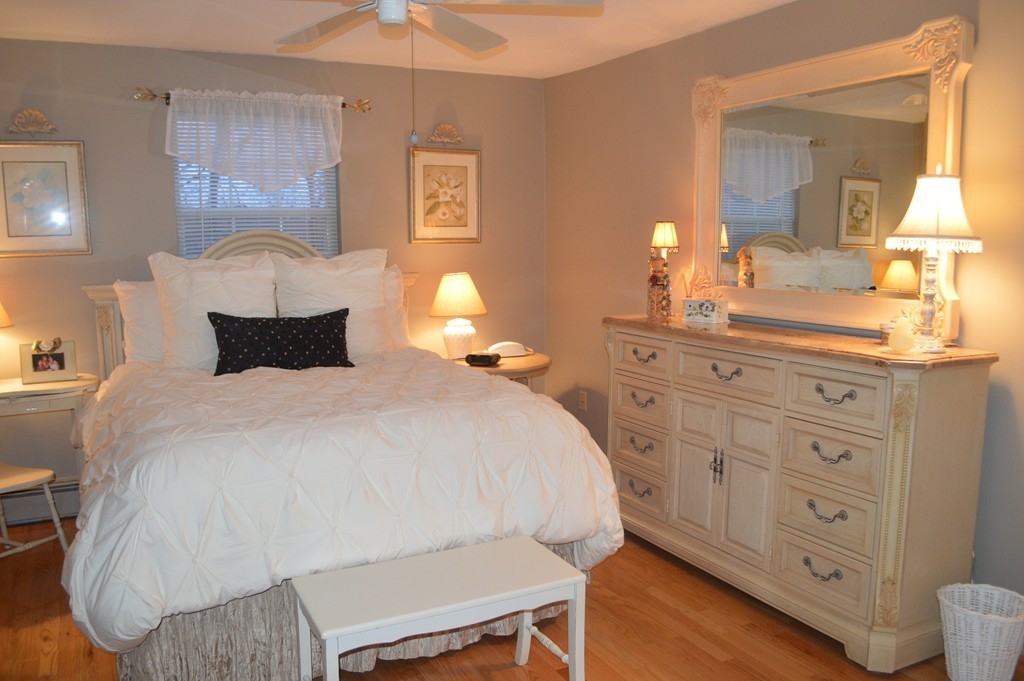 64 Jacqueline Road, Unit 5 Waltham, MA 02452 - Photo 7 of 10 a bedroom with a bed and a dresser