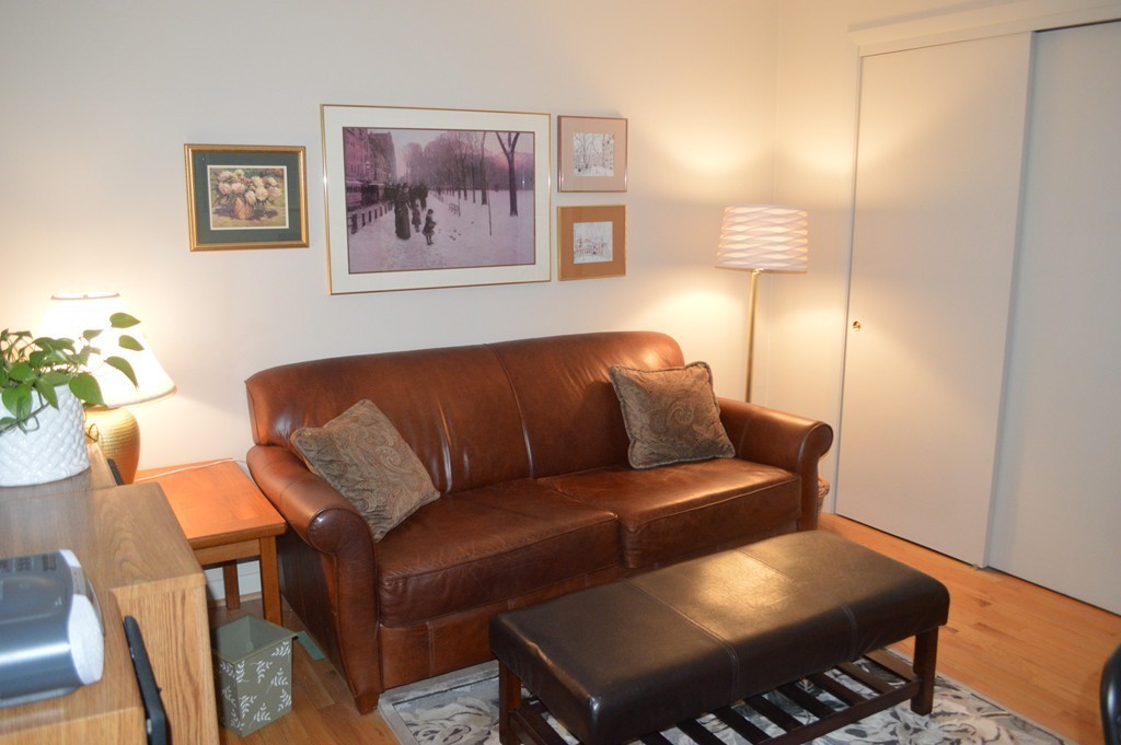 64 Jacqueline Road, Unit 5 Waltham, MA 02452 - Photo 8 of 10 a living room with furniture and a lamp