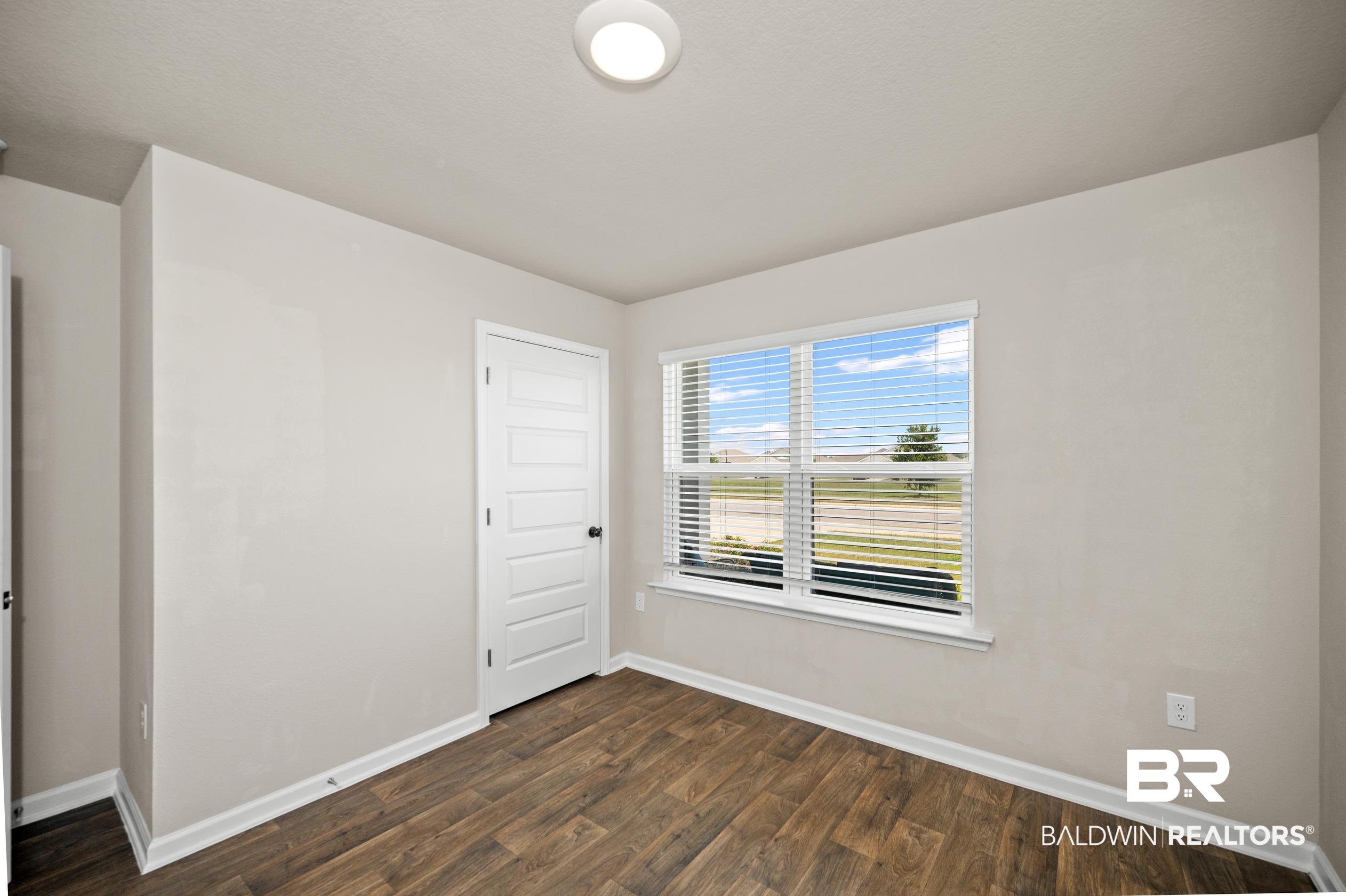 10353 Zenyatta Loop Daphne, AL 36526 - Photo 20 of 33 Unfurnished room featuring dark wood-type flooring