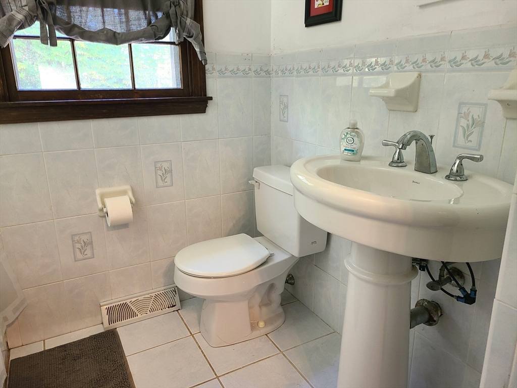 131 Holly Ridge Drive Hanson, MA 02341 - Photo 17 of 36 a bathroom with a sink a toilet and a mirror