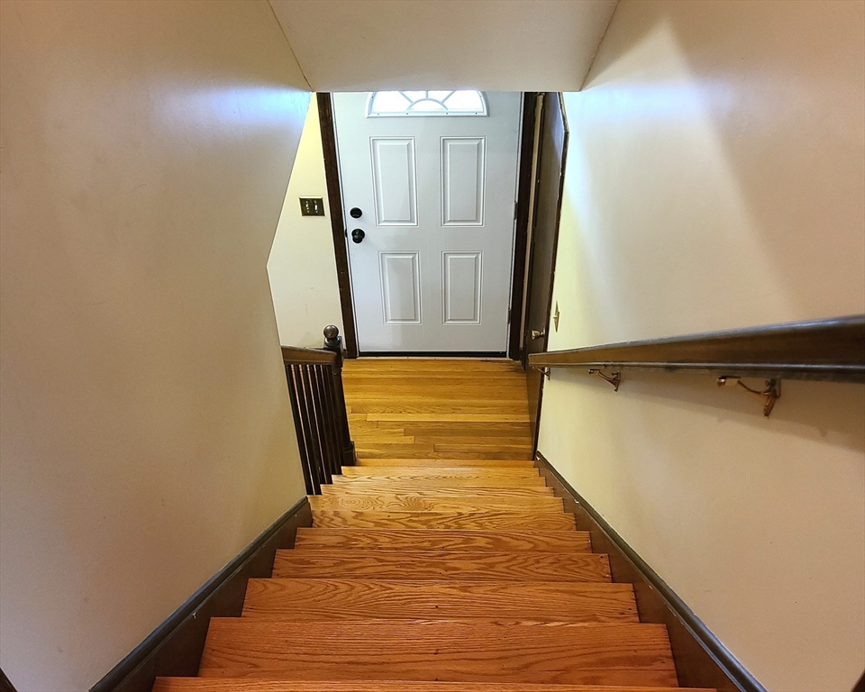 131 Holly Ridge Drive Hanson, MA 02341 - Photo 19 of 36 a view of a hallway with wooden floor and staircase