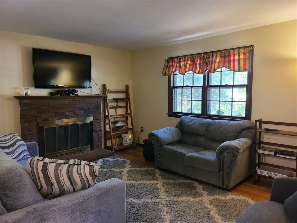 131 Holly Ridge Drive Hanson, MA 02341 - Photo 3 of 36 a living room with furniture and a flat screen tv