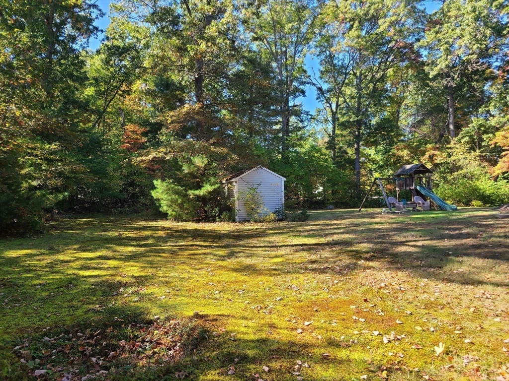 131 Holly Ridge Drive Hanson, MA 02341 - Photo 34 of 36 a view of a swimming pool with a garden