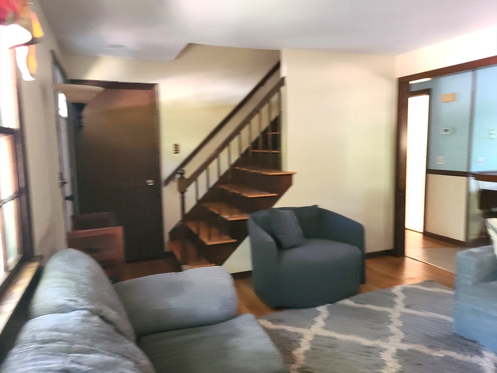 131 Holly Ridge Drive Hanson, MA 02341 - Photo 5 of 36 a living room with furniture and stairs