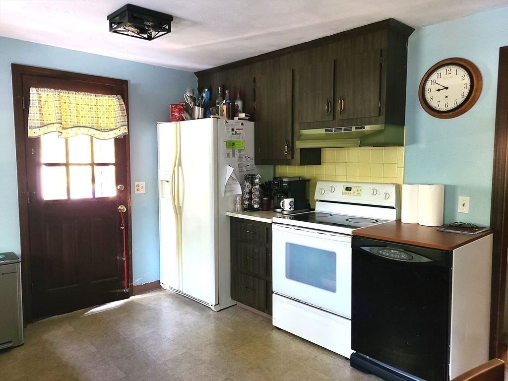 131 Holly Ridge Drive Hanson, MA 02341 - Photo 8 of 36 a kitchen with a refrigerator and a stove top oven