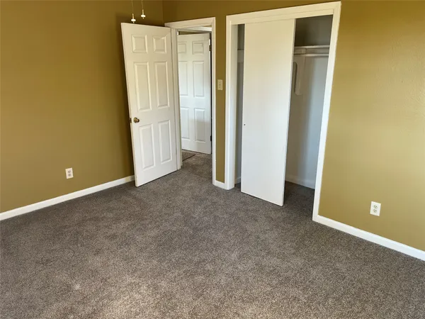 an empty room with closet area