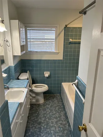 a bathroom with a toilet a sink and a bathtub