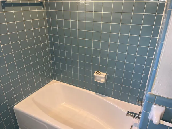 a bathroom with a blue toilet