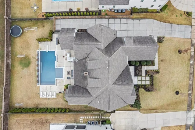 a dining room with furniture a chandelier and wooden floor