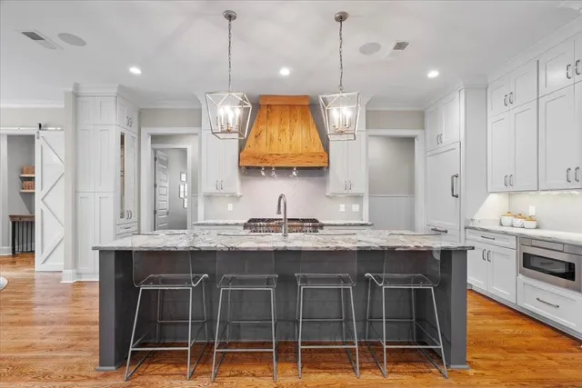a bathroom with a granite countertop toilet a sink and a mirror