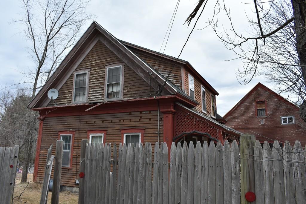 96 Fitchburg Road Townsend, MA 01469 - Photo 5 of 19 a front view of a house with a wooden fence