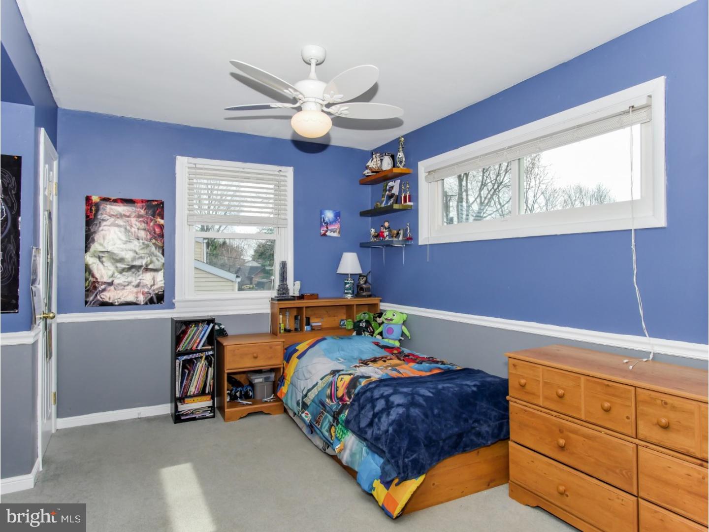 604 Exton Road Hatboro, PA 19040 - Photo 12 of 21 a bedroom with a bed and a chandelier