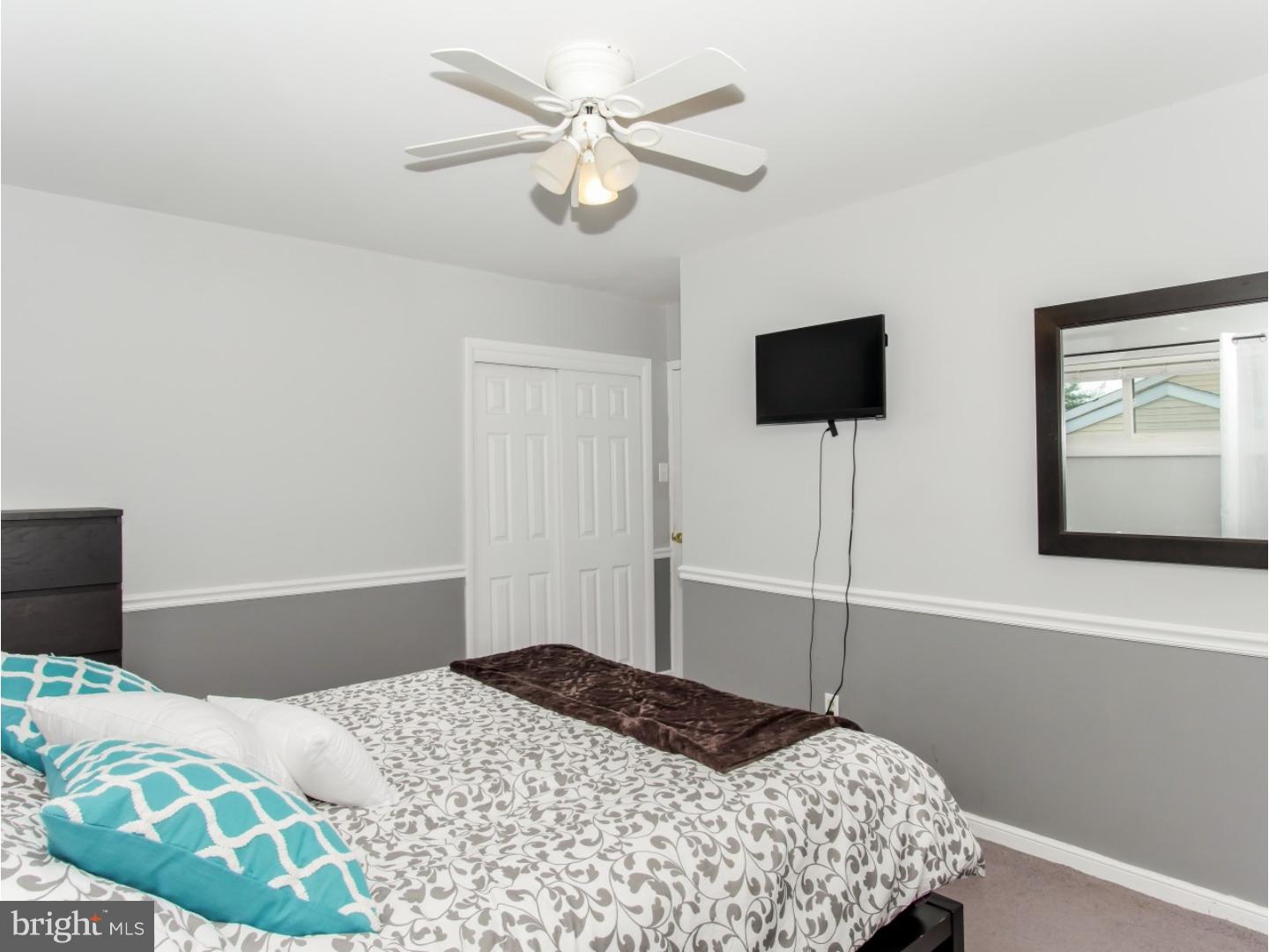 604 Exton Road Hatboro, PA 19040 - Photo 15 of 21 a bedroom with a bed and a flat screen tv