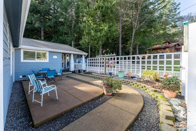 a view of a patio with couches chairs and wooden floor
