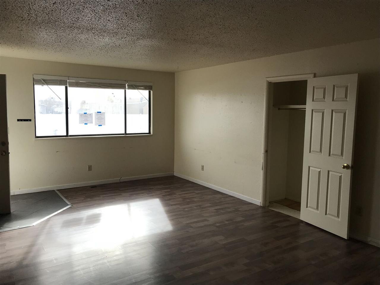 3240 D D 1/4 Road, Unit A&B Clifton, CO 81520 - Photo 12 of 19 an empty room with wooden floor and windows