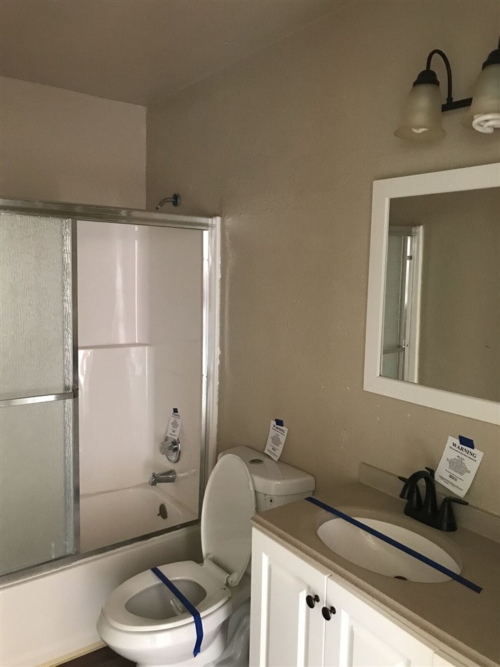 3240 D D 1/4 Road, Unit A&B Clifton, CO 81520 - Photo 9 of 19 a bathroom with a granite countertop toilet sink and shower