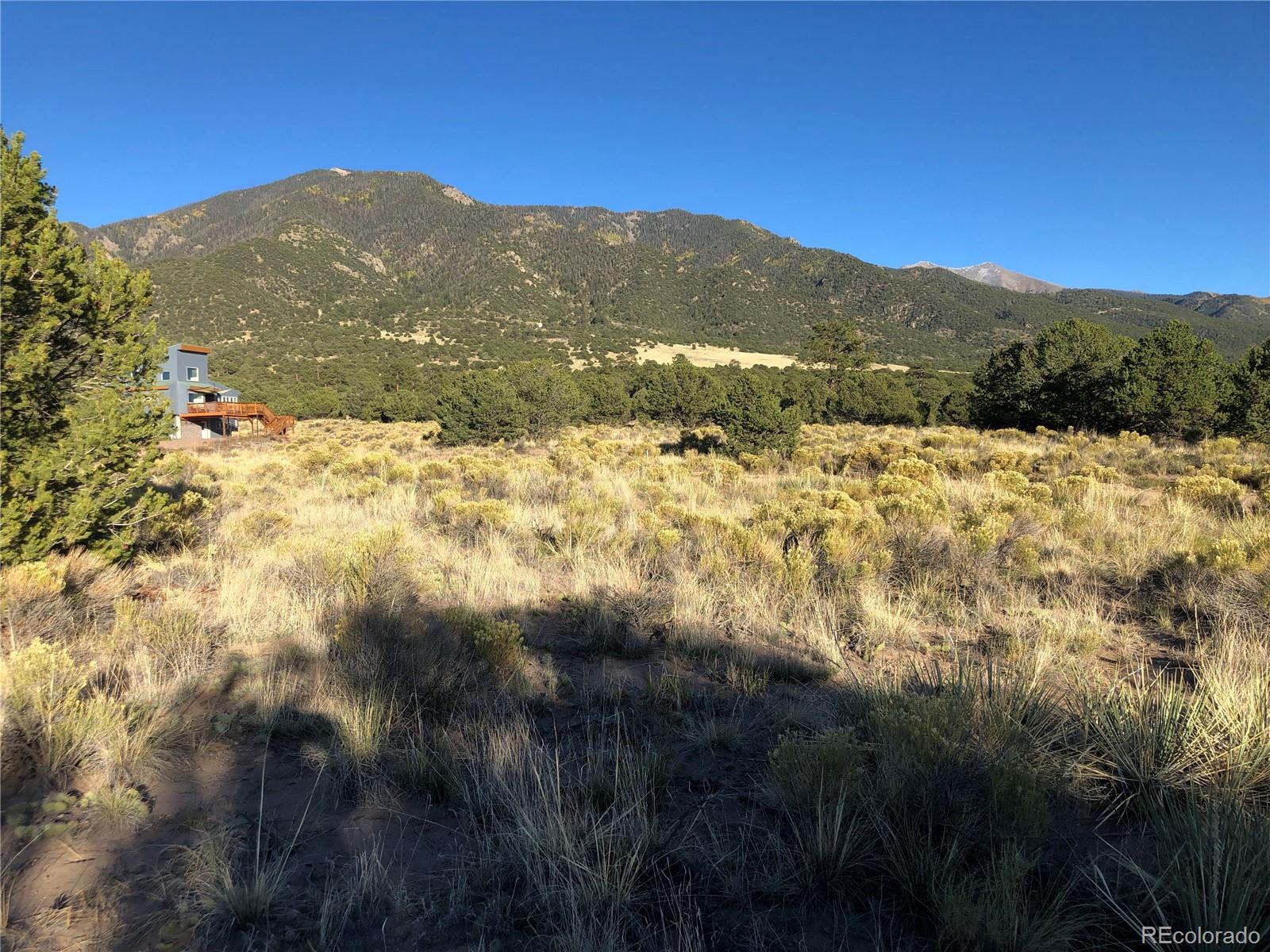 4480 Ridgecrest Way Crestone, CO 81131 - Photo 8 of 24 a view of a mountain range with a lush green hillside