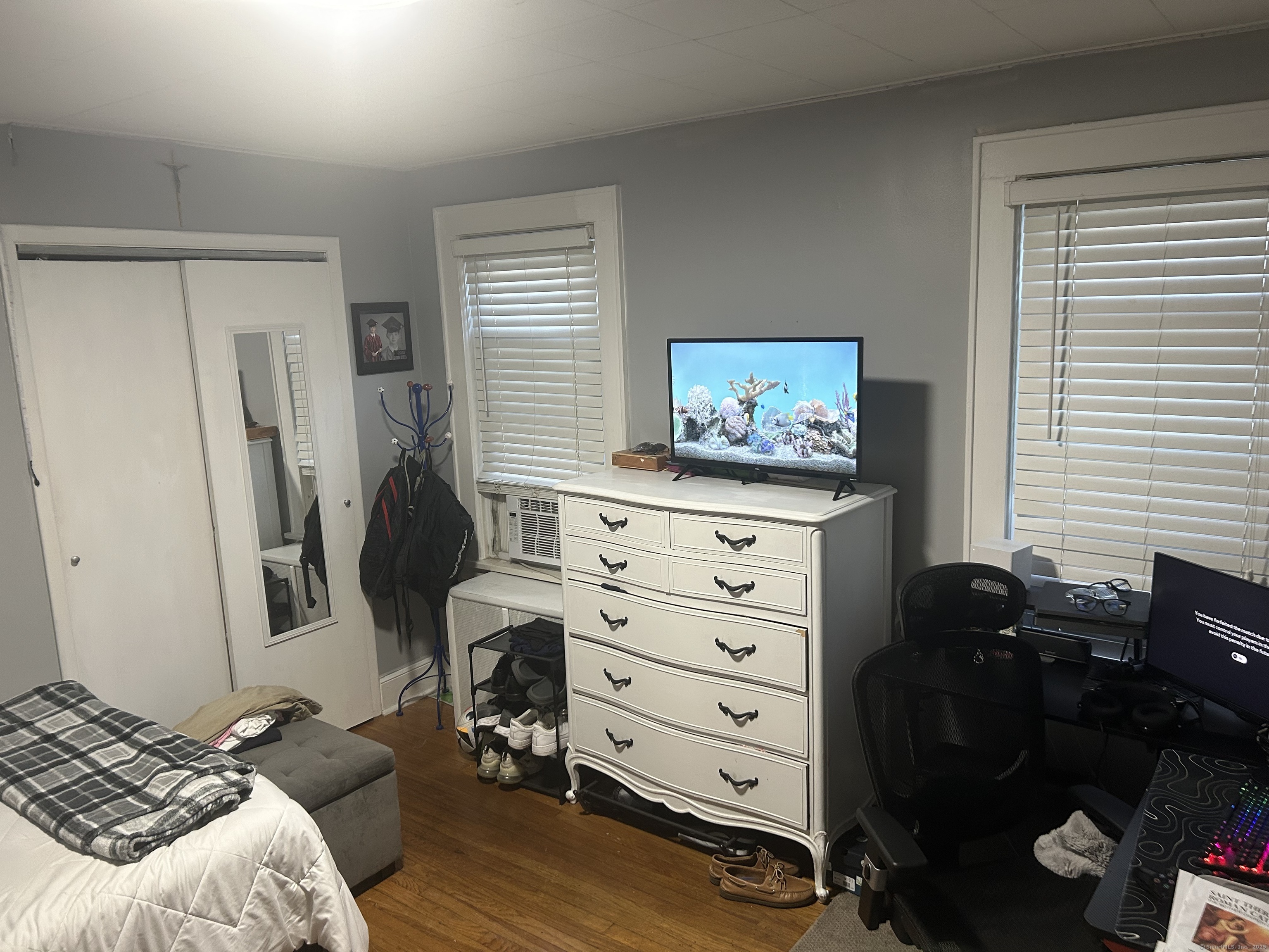 1515 Capitol Avenue Bridgeport, CT 06604 - Photo 11 of 17 a bedroom with a bed and a flat tv screen