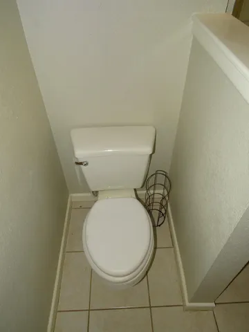 a white toilet sitting next to a white sink