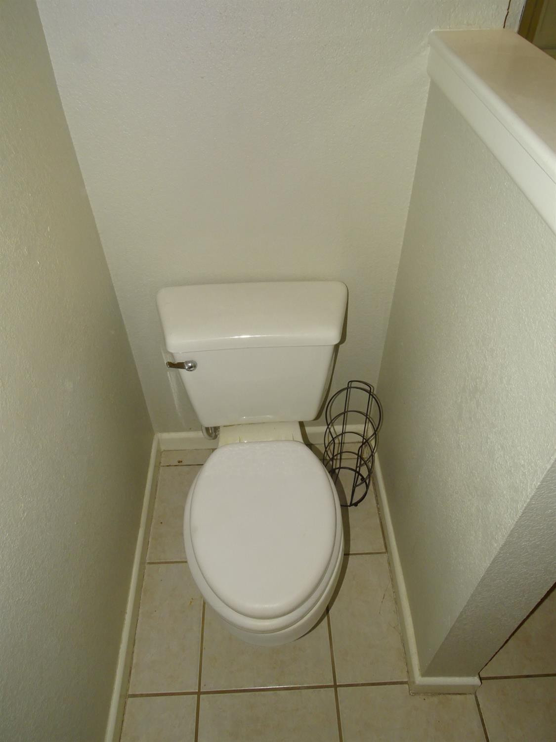 4920 17th Street Lubbock, TX 79416 - Photo 13 of 33 a white toilet sitting next to a white sink