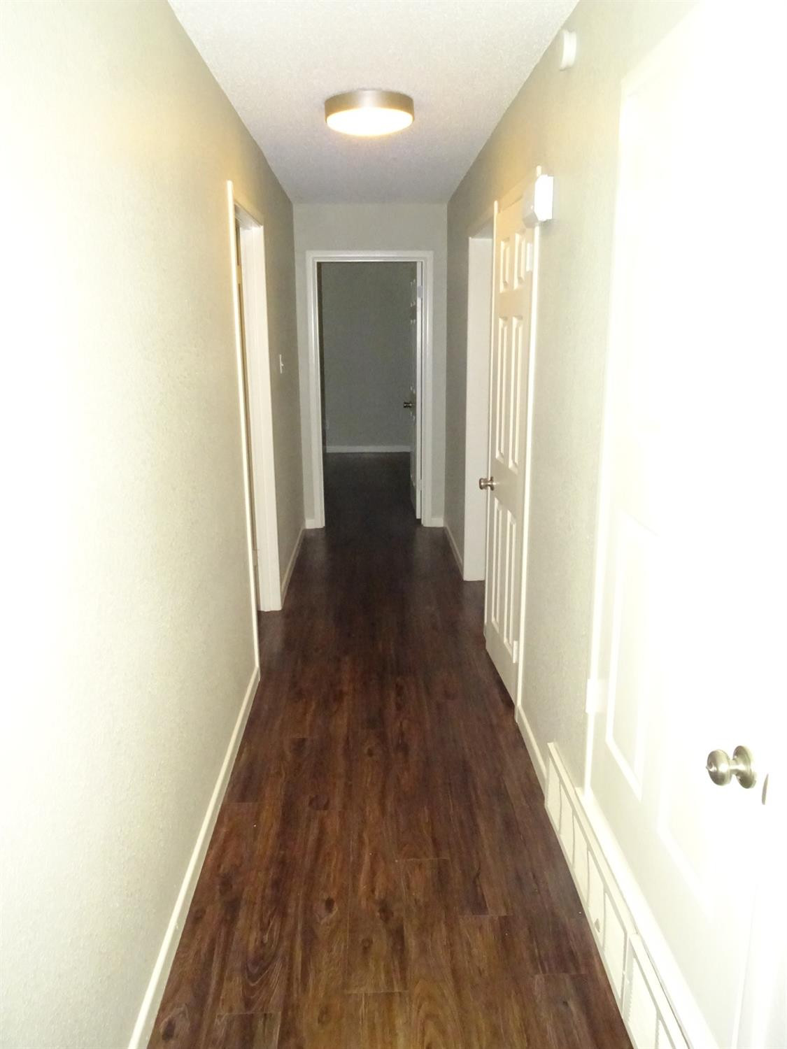 4920 17th Street Lubbock, TX 79416 - Photo 20 of 33 a view of a hallway with wooden floor