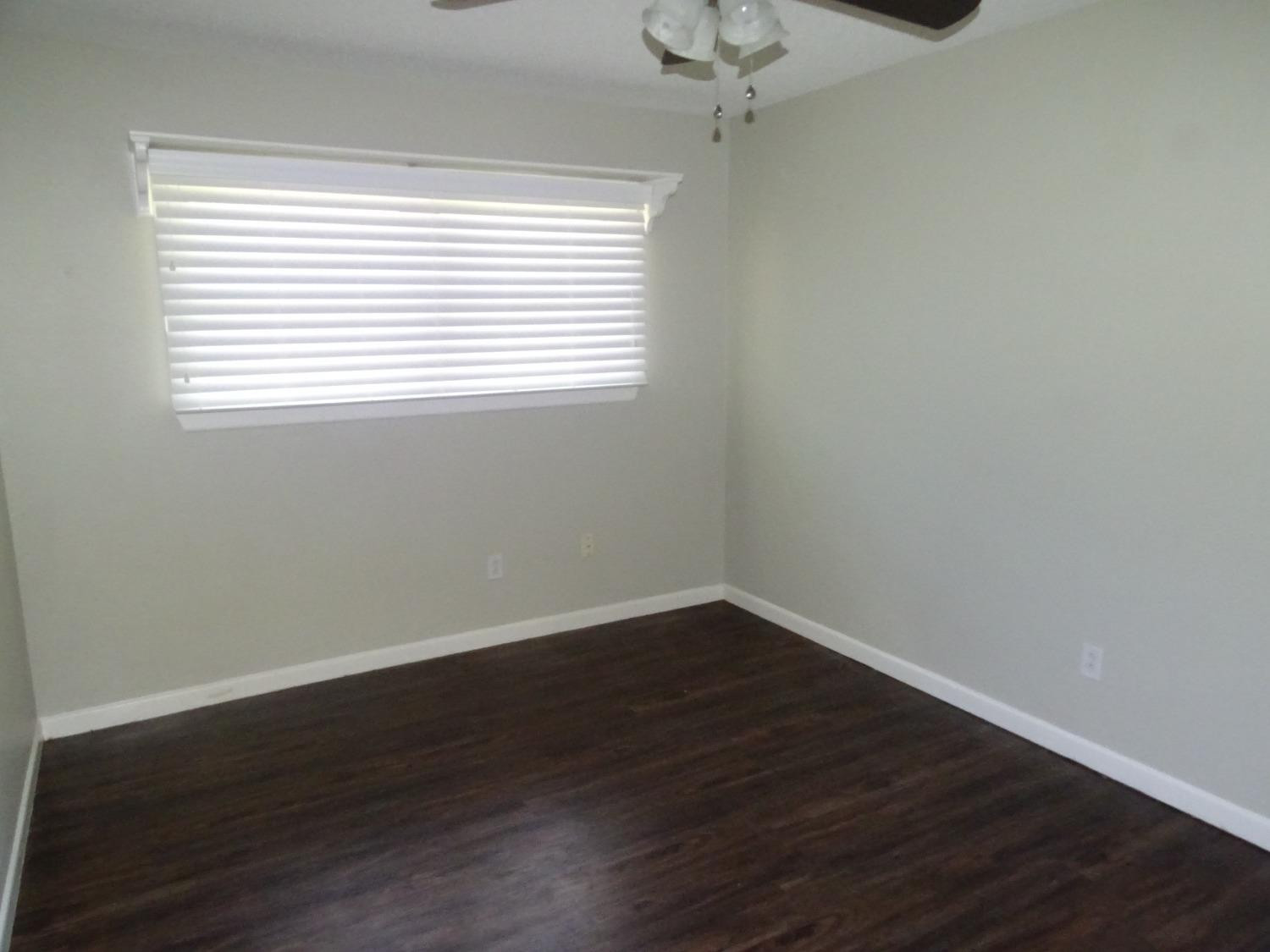 4920 17th Street Lubbock, TX 79416 - Photo 24 of 33 a view of an empty room with wooden floor and a window