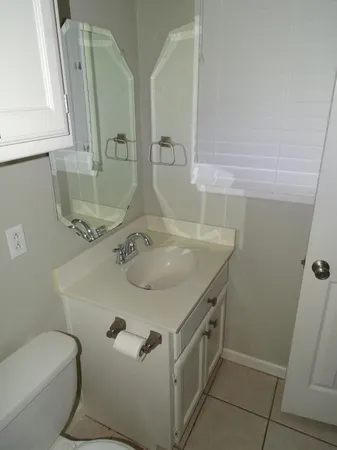 a bathroom with a sink toilet and mirror