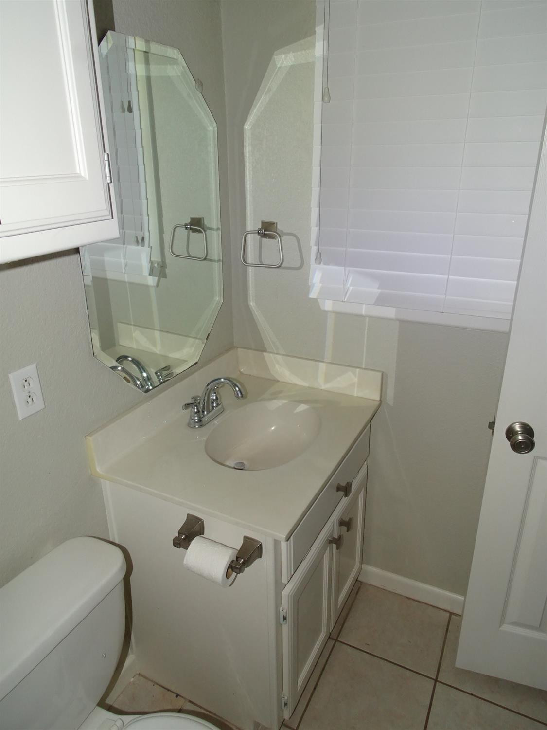 4920 17th Street Lubbock, TX 79416 - Photo 29 of 33 a bathroom with a sink toilet and mirror