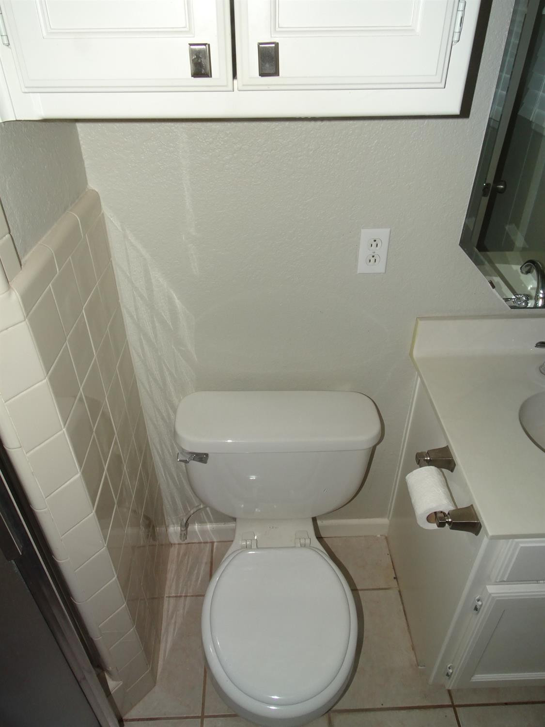 4920 17th Street Lubbock, TX 79416 - Photo 30 of 33 a white toilet sitting next to a white sink and vanity