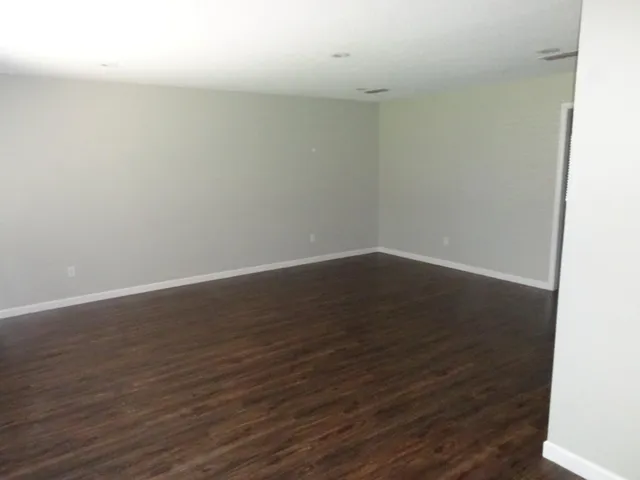 a view of a room with wooden floor