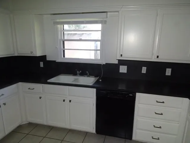 a kitchen with a sink and cabinets