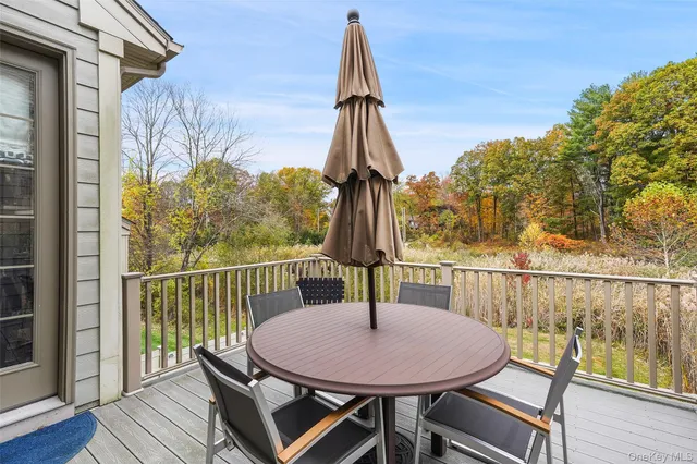 a view of a chairs and table in the balcony
