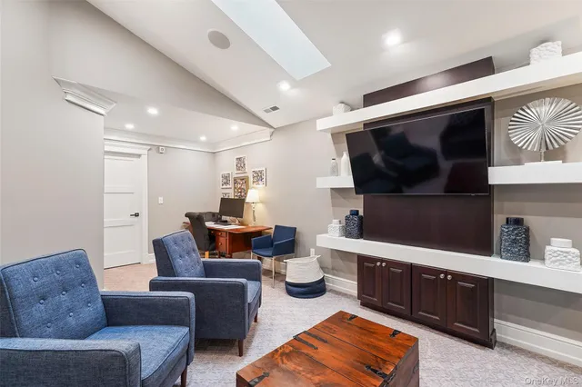 a living room with furniture a flat screen tv and a large window
