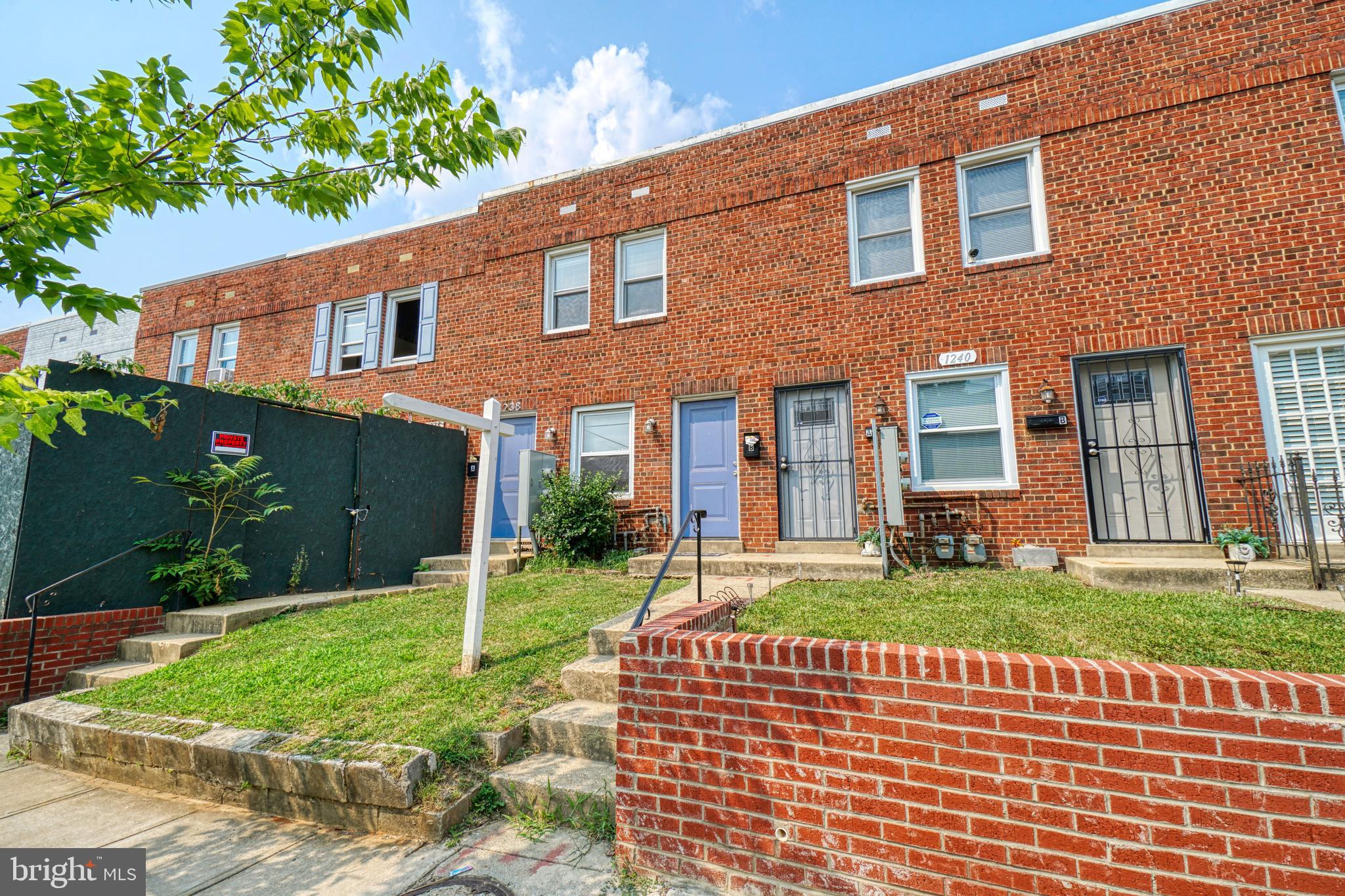 1238 Simms Place Northeast, Unit A Washington, DC 20002 - Photo 1 of 18 a front view of a house with a yard
