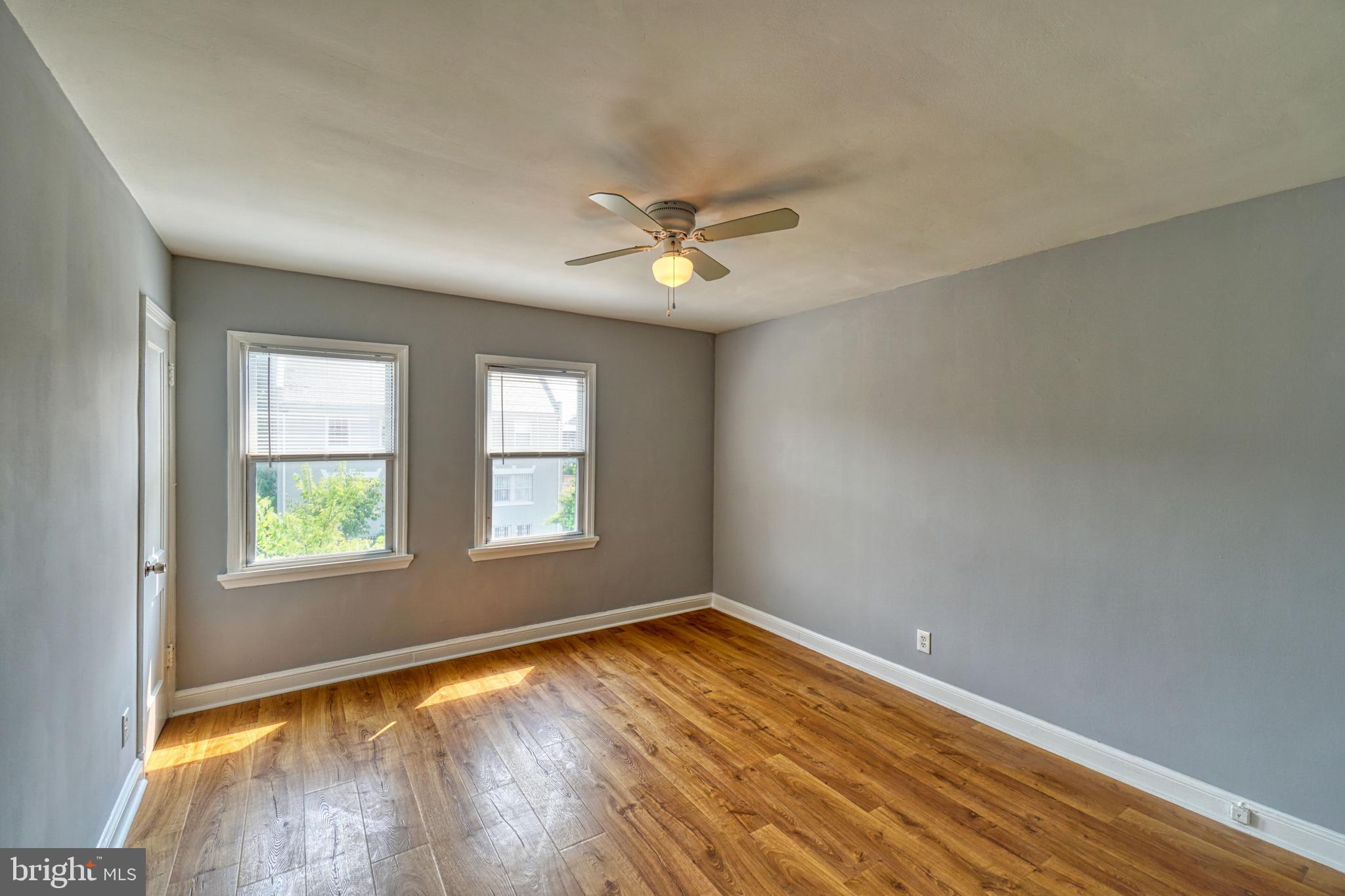 1238 Simms Place Northeast, Unit A Washington, DC 20002 - Photo 11 of 18 an empty room with a window and a ceiling fan