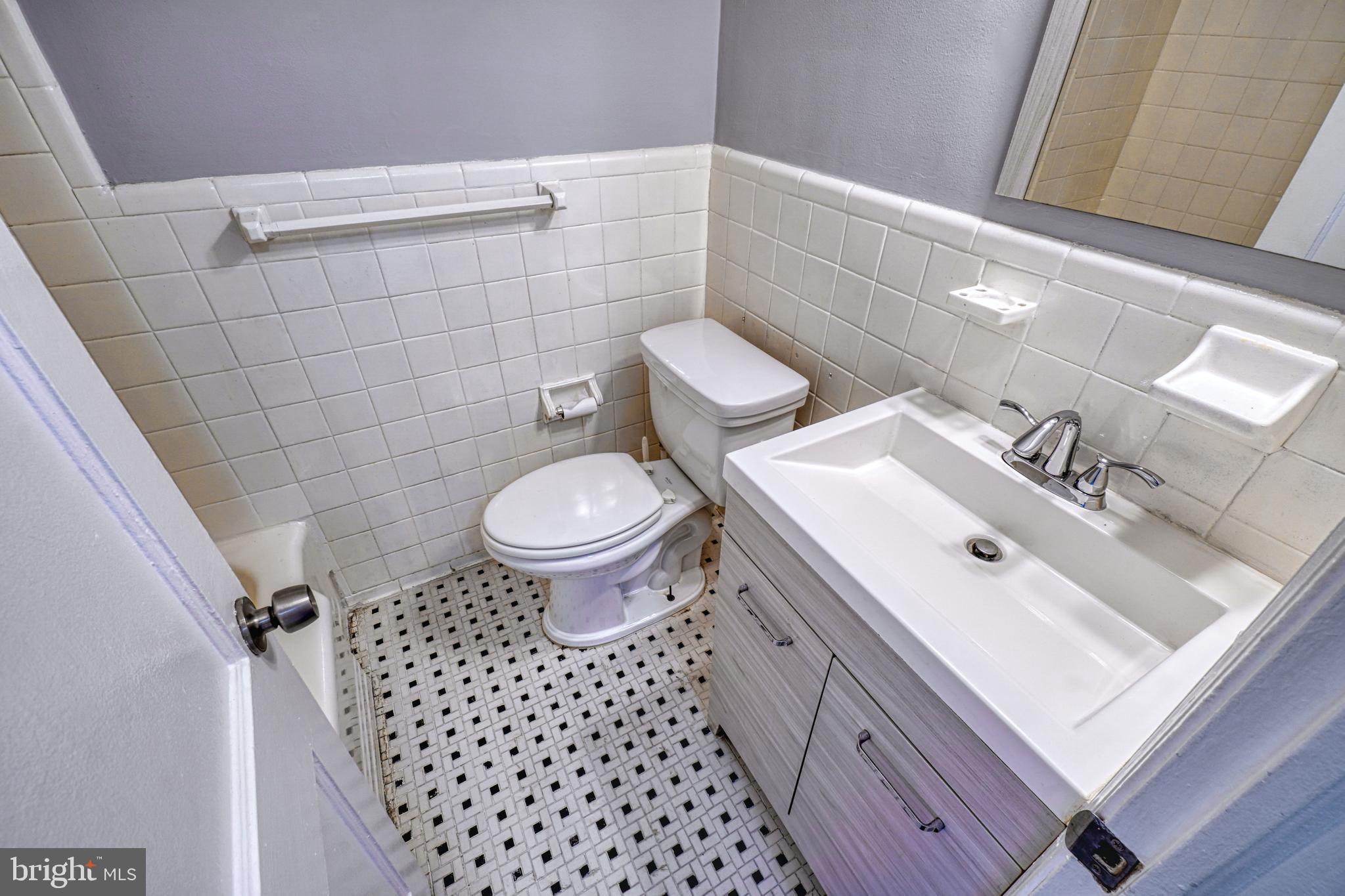 1238 Simms Place Northeast, Unit A Washington, DC 20002 - Photo 13 of 18 a bathroom with a sink toilet and shower