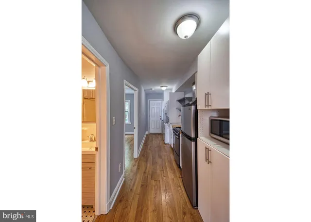 a kitchen with a sink and a stove top oven