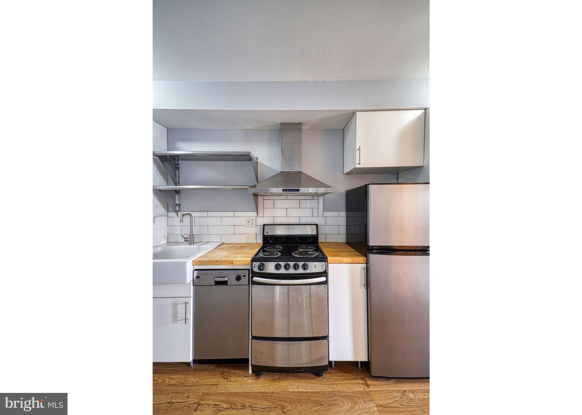 1238 Simms Place Northeast, Unit A Washington, DC 20002 - Photo 5 of 18 a kitchen with a sink and a stove top oven