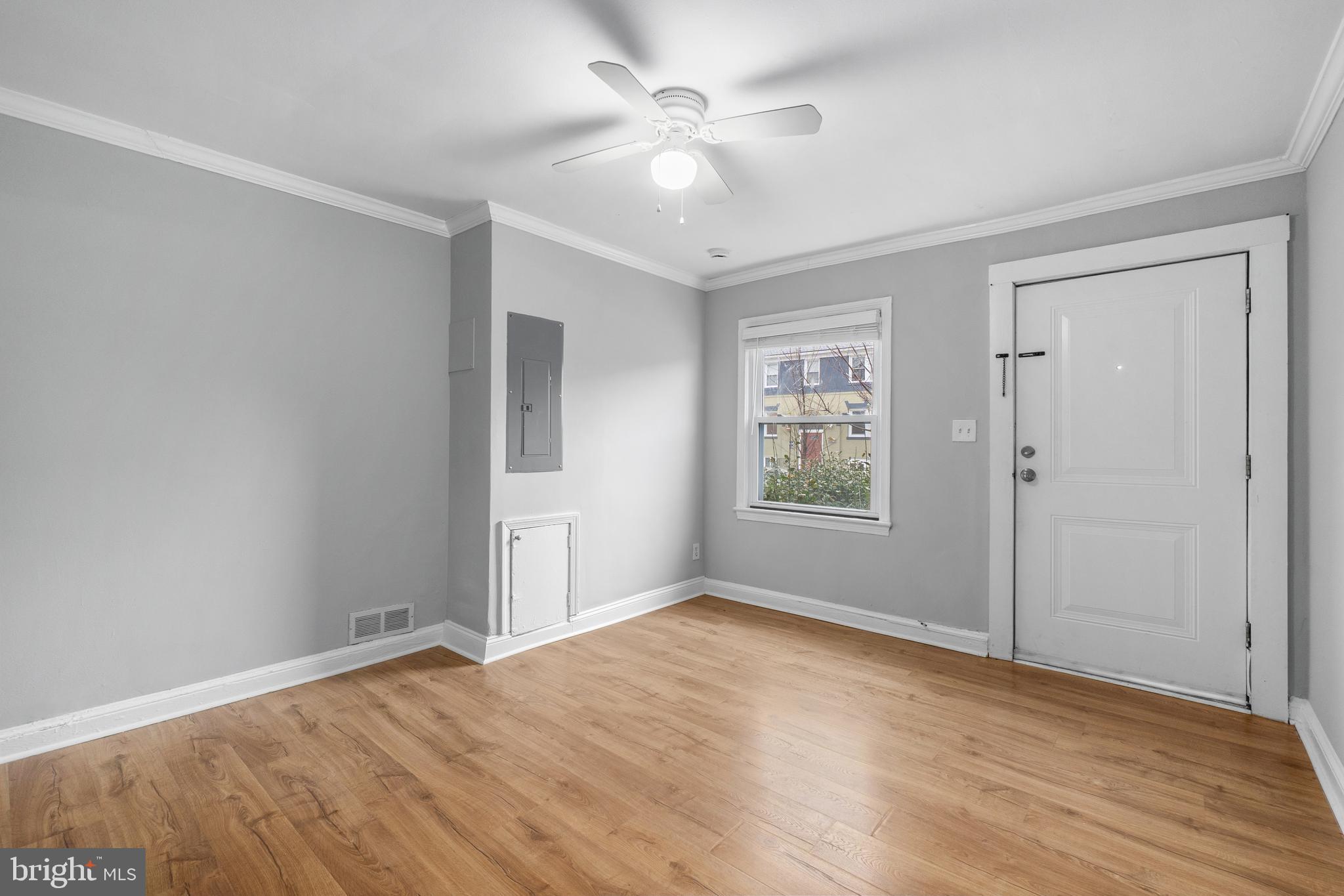 1238 Simms Place Northeast, Unit A Washington, DC 20002 - Photo 6 of 16 wooden floor in an empty room with a window