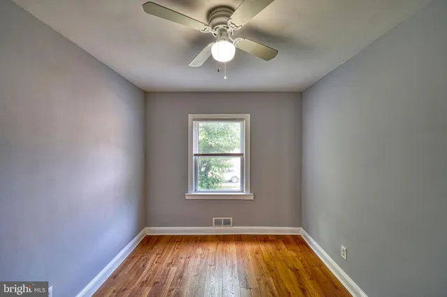 wooden floor in an empty room with a window