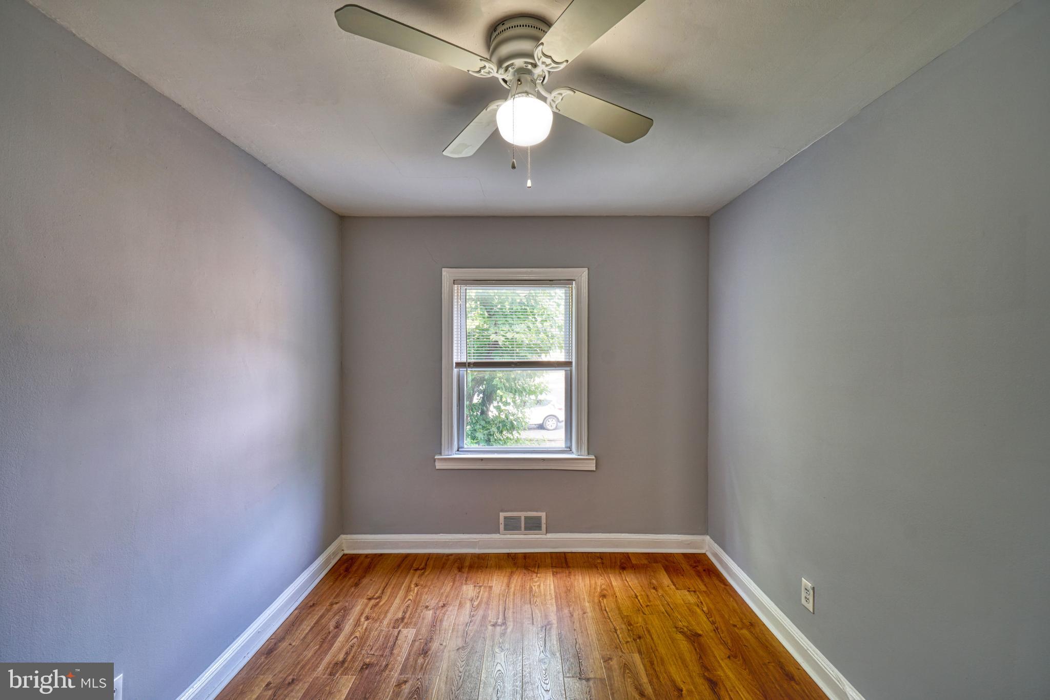 1238 Simms Place Northeast, Unit A Washington, DC 20002 - Photo 8 of 18 wooden floor in an empty room with a window