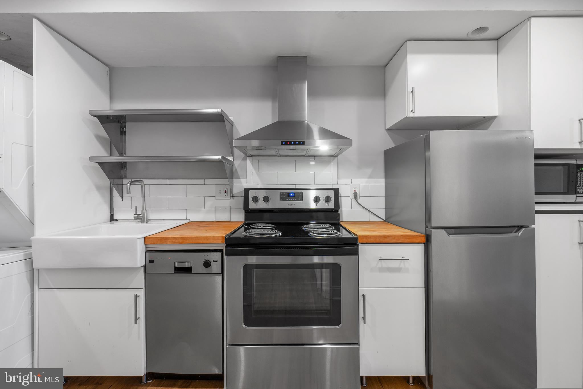 1238 Simms Place Northeast, Unit A Washington, DC 20002 - Photo 8 of 16 a stove top oven sitting inside of a kitchen
