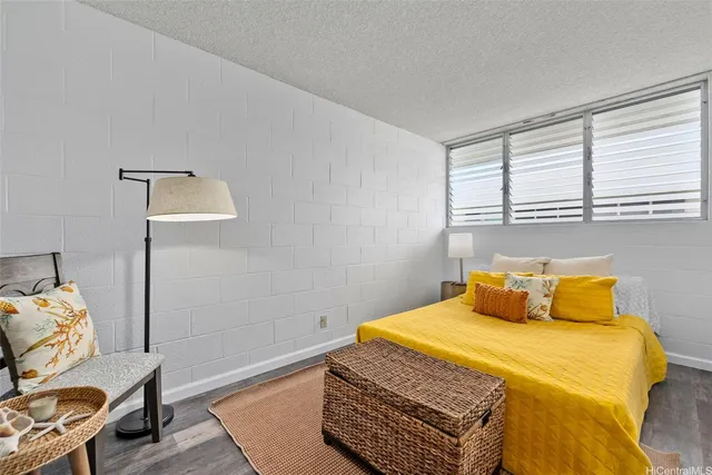 a bedroom with a bed and chair