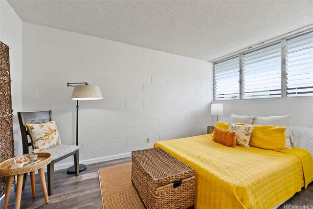 a bedroom with a bed and a lamp on the table