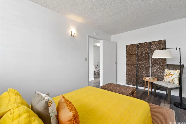 a bedroom with a bed a table and chair