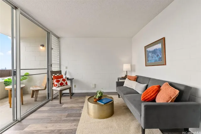 a living room with furniture and a floor to ceiling window