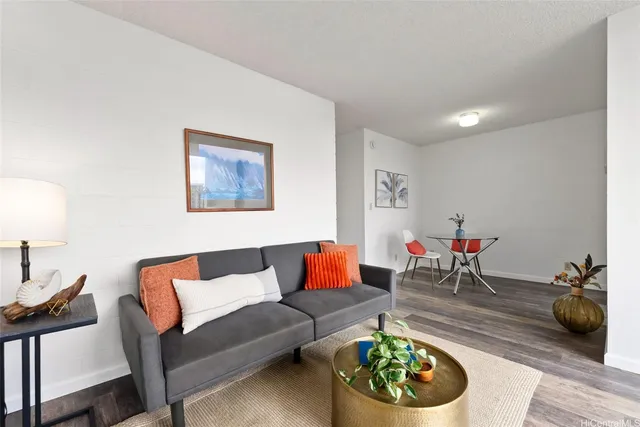 a living room with furniture and a potted plant